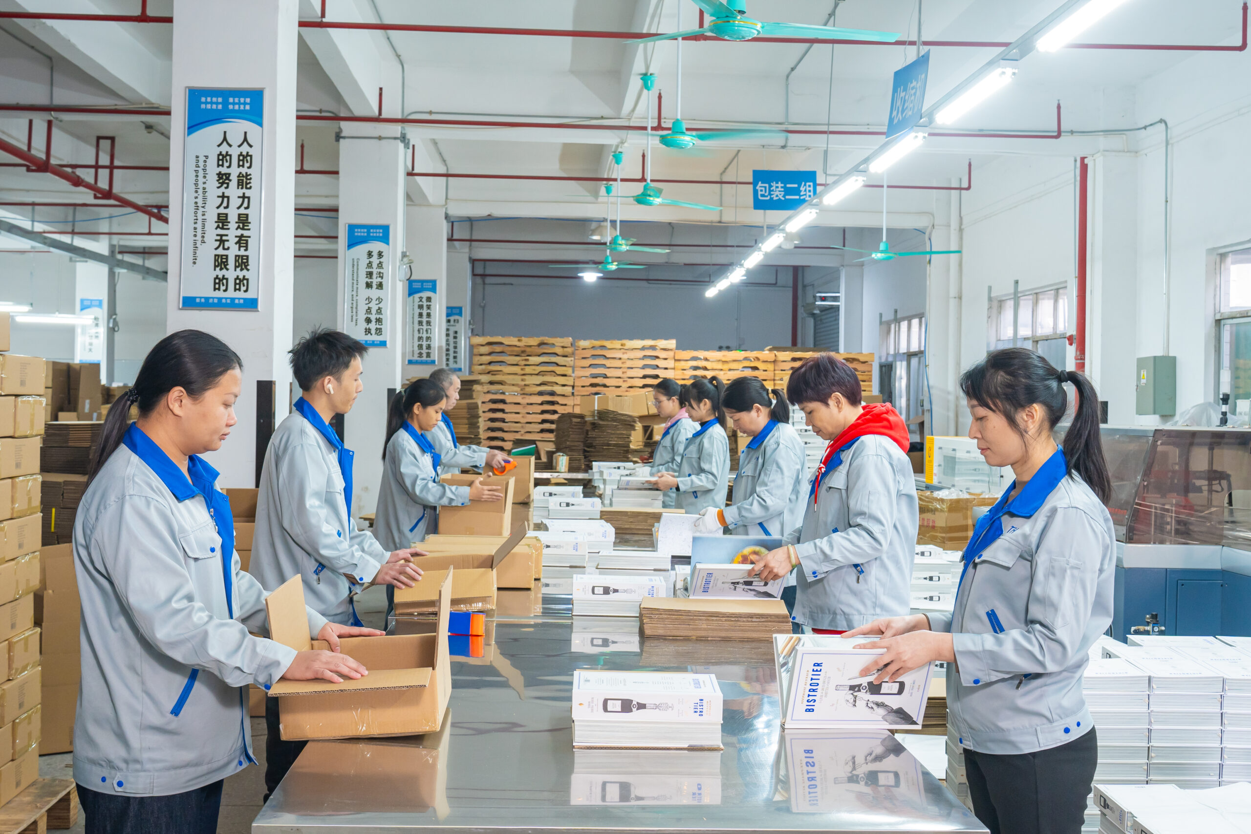 Factory staff packaging custom hardcover books for shipment